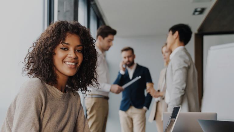 alpadia career pathway woman smiling and people standing behind