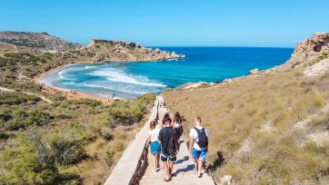 students walking toward a beach in Malta